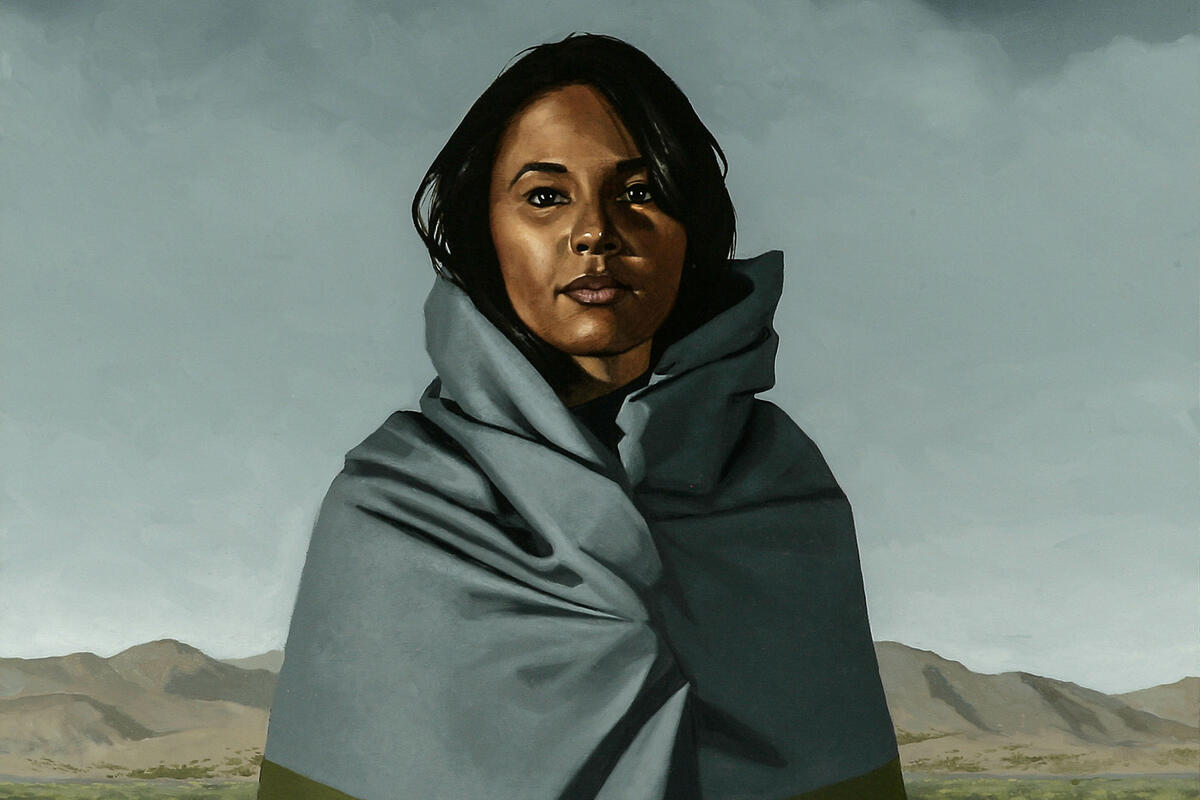 painting of woman in desert wrapped in blanket