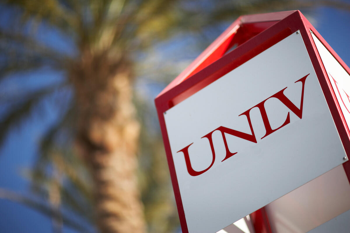 UNLV signage with palm tree in background