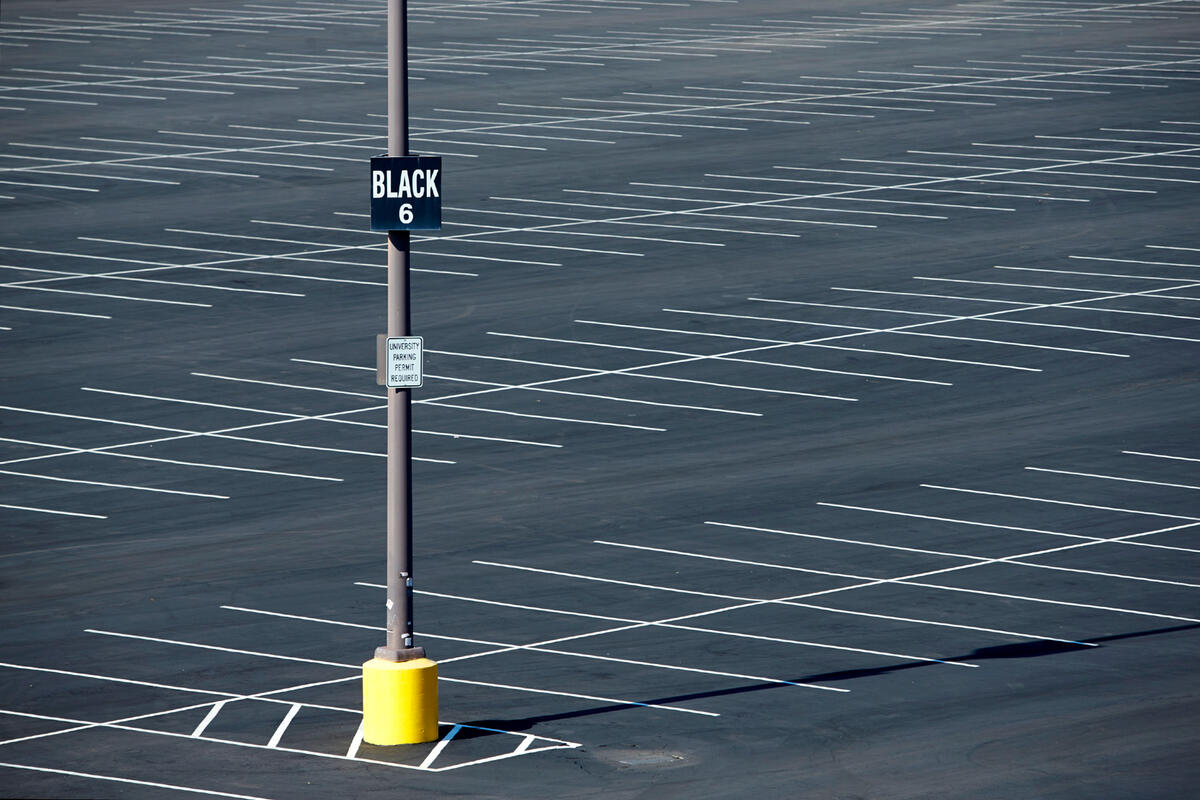 empty parking lot with lot name on sign