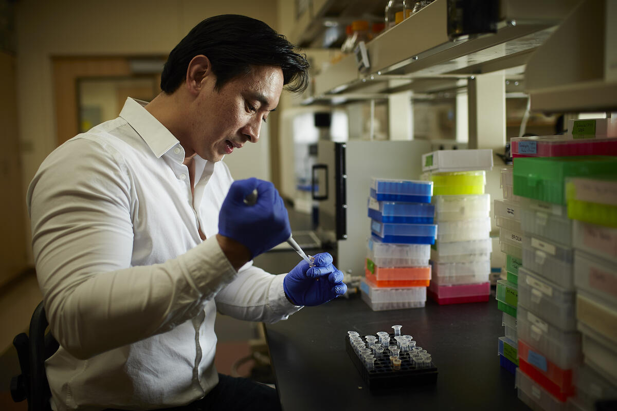 UNLV researcher Edwin Oh holds a pipette in his lab on campus.