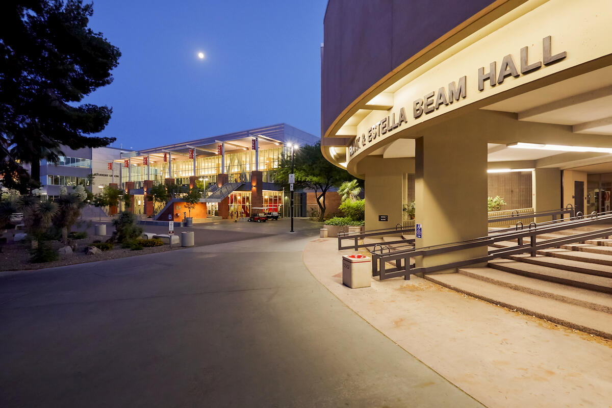 The exterior of Beam Hall and the student union lit up at night