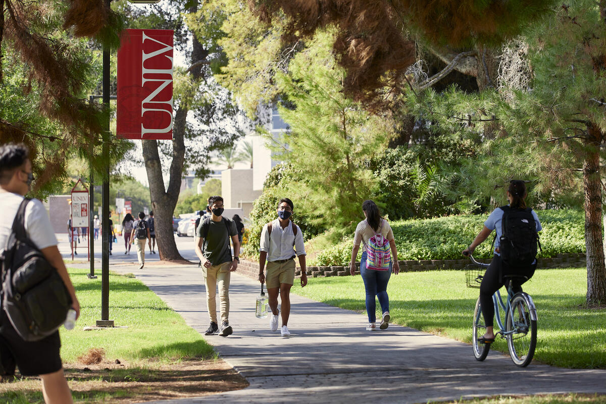 Students walking on campus on sunny day