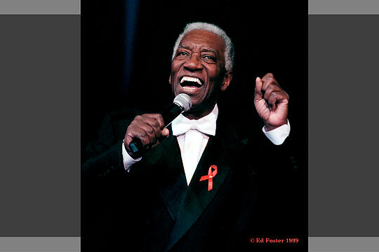 Joe Williams singing into microphone