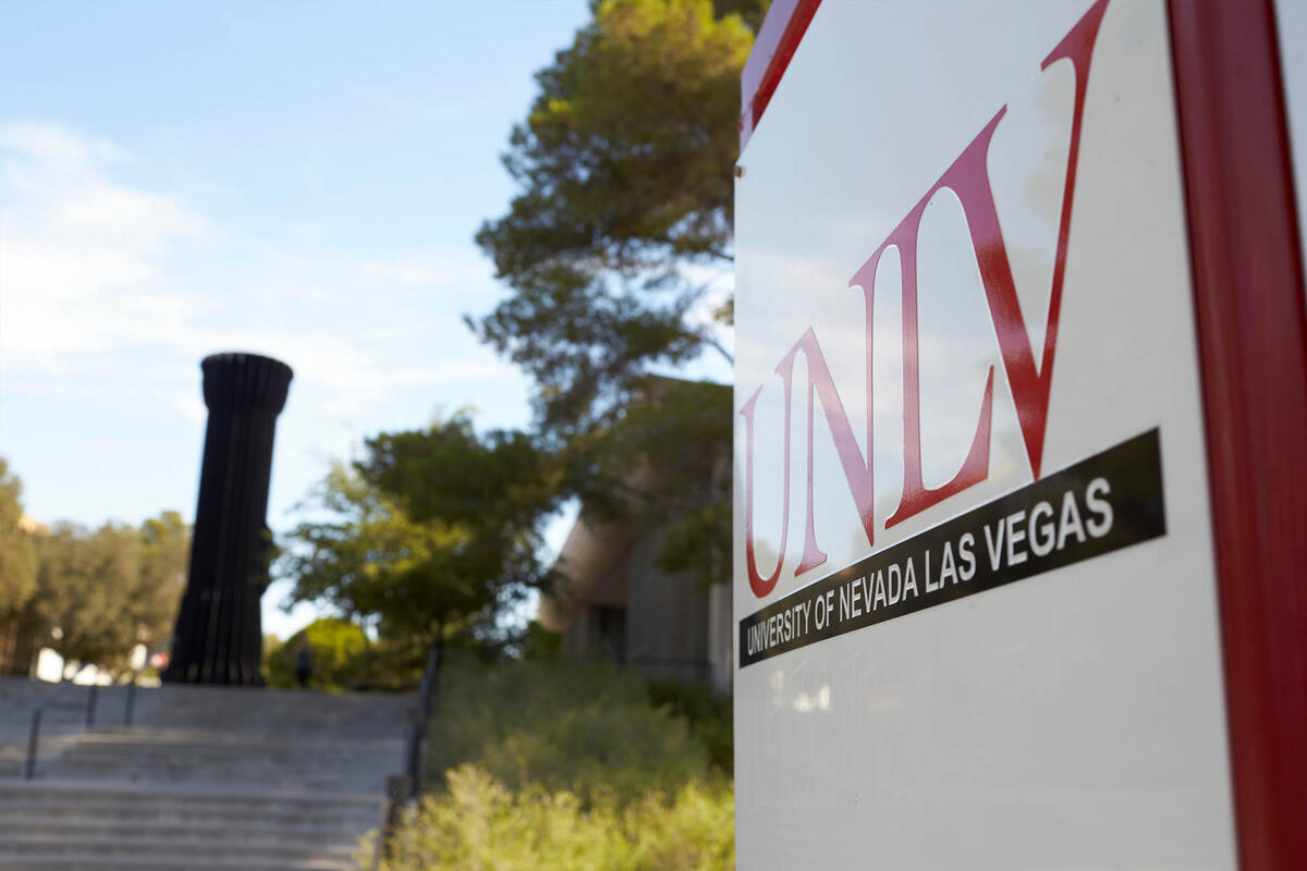 The Flashlight is seen from a distance with a UNLV sign in the foreground