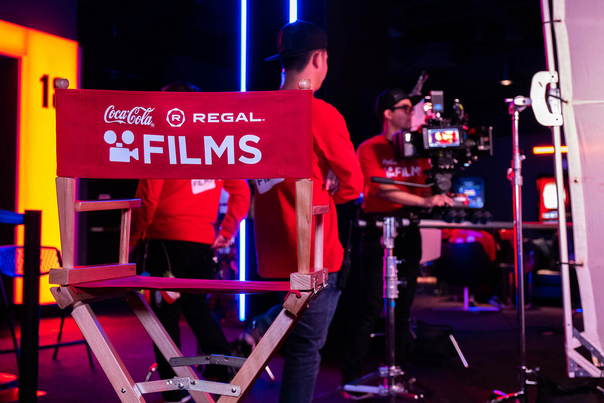 director's chair with film crew in background