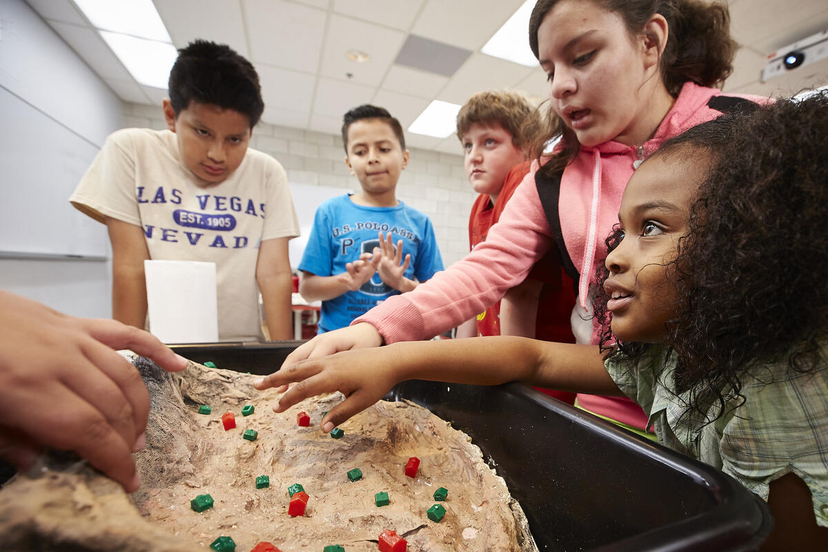A group of five fifth graders partake in an experiment during UNLV's Rebel Science Camp.