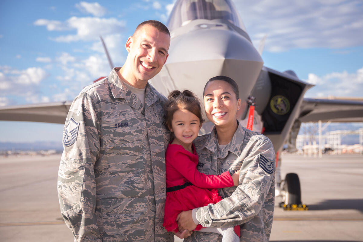 Alexandria Sawin poses for a photo with her daughter and husband.