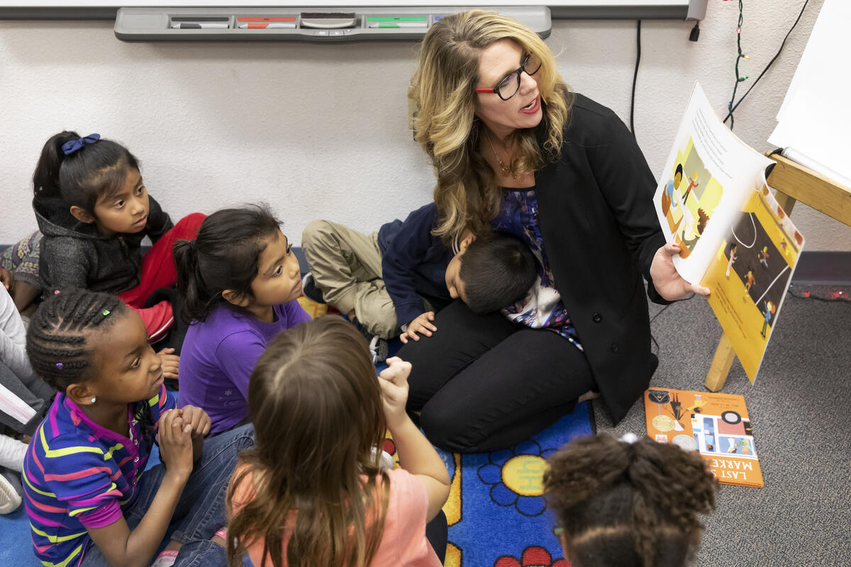 UNLV assistant professor Sophie Ladd reads a book to a group of students.
