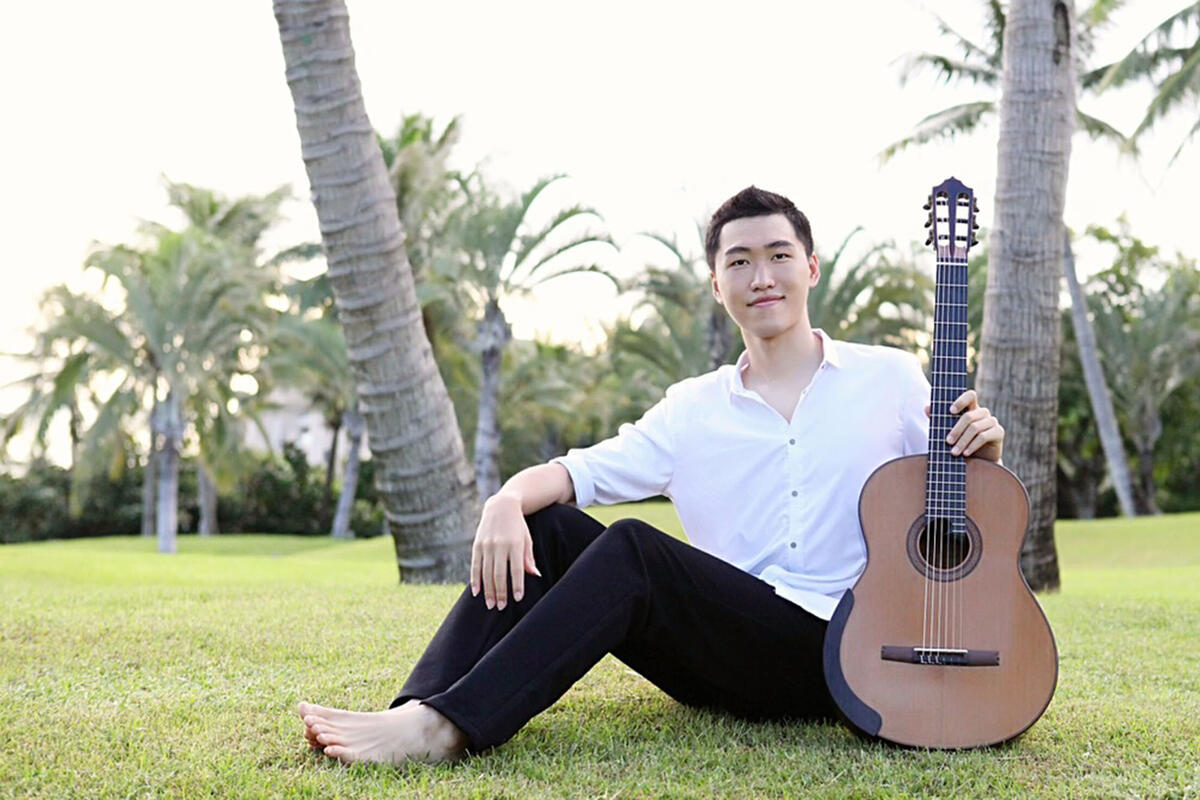 male guitarist pictured outdoors