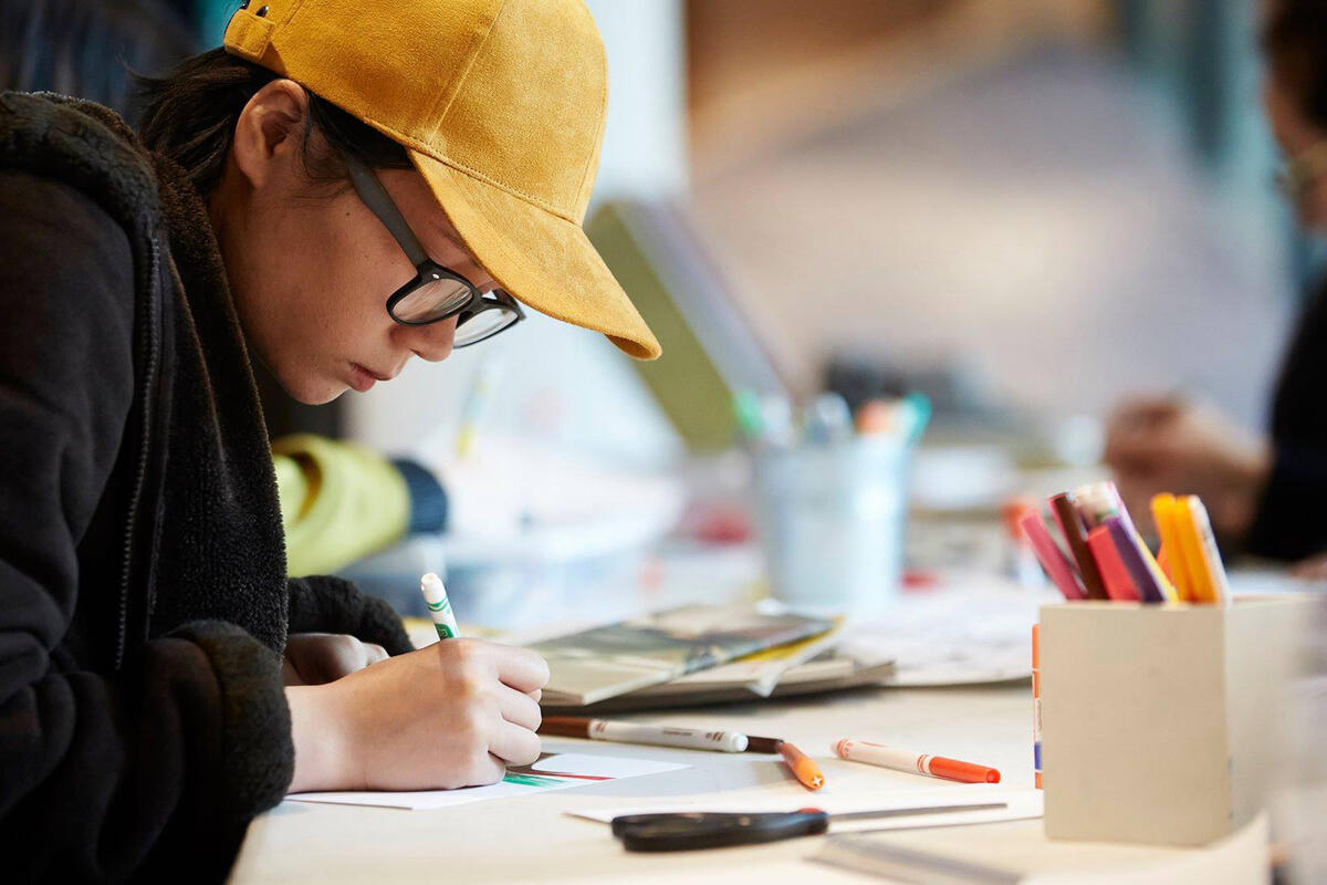 woman working with paper and markers