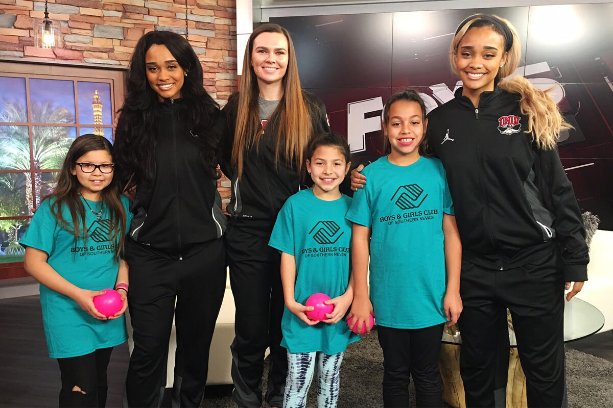 UNLV athelites pose next children from the Boys and Girls Club