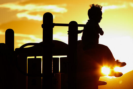 Silhouette of a child on a playground