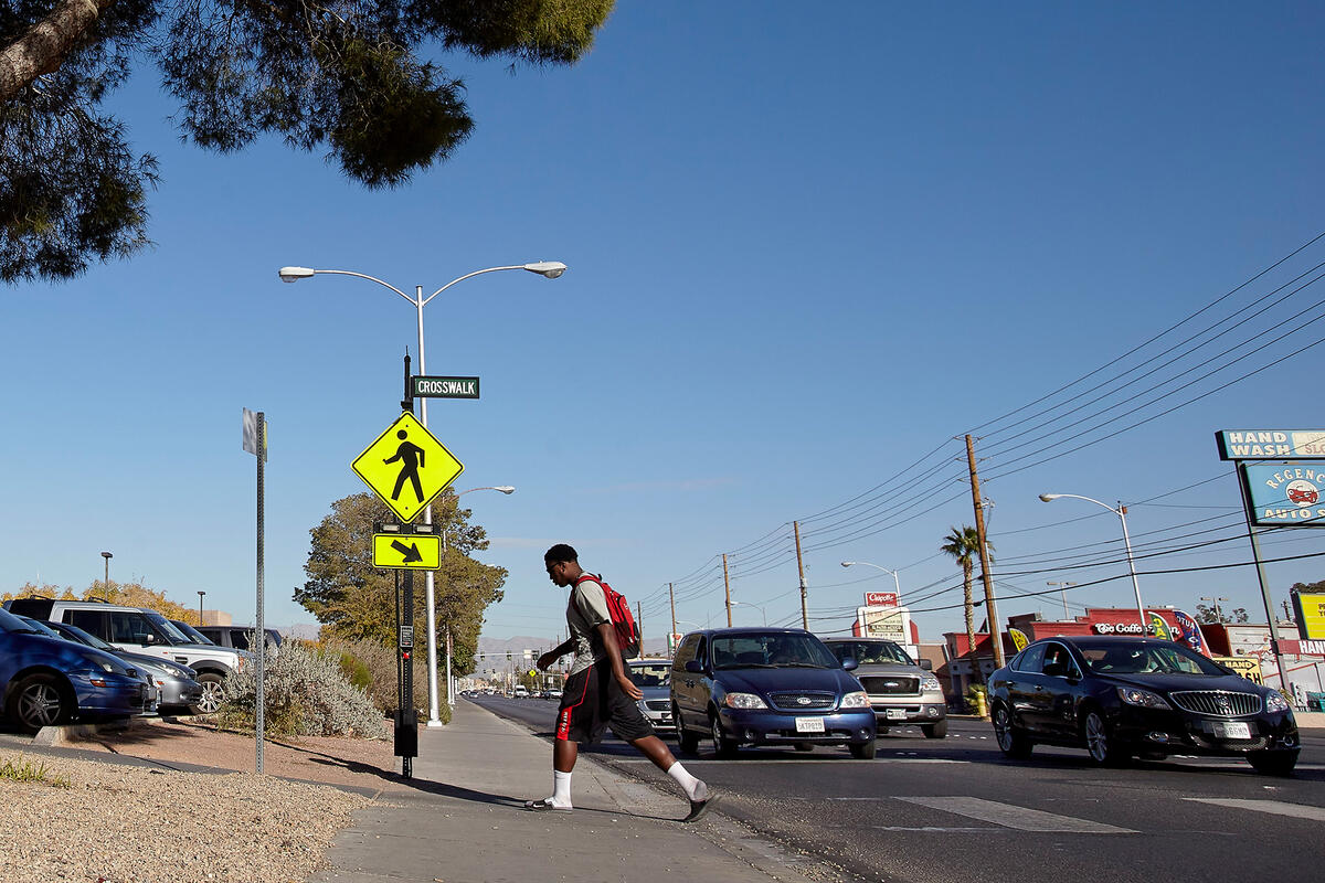 A pedestrian exiting a crosswalk on Maryland Parkway