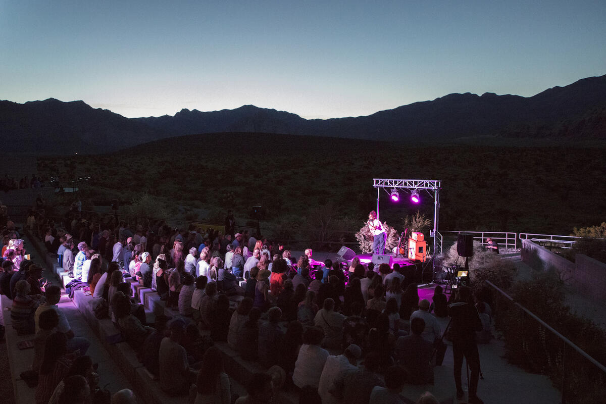 crowd in front of stage at outdoor concert