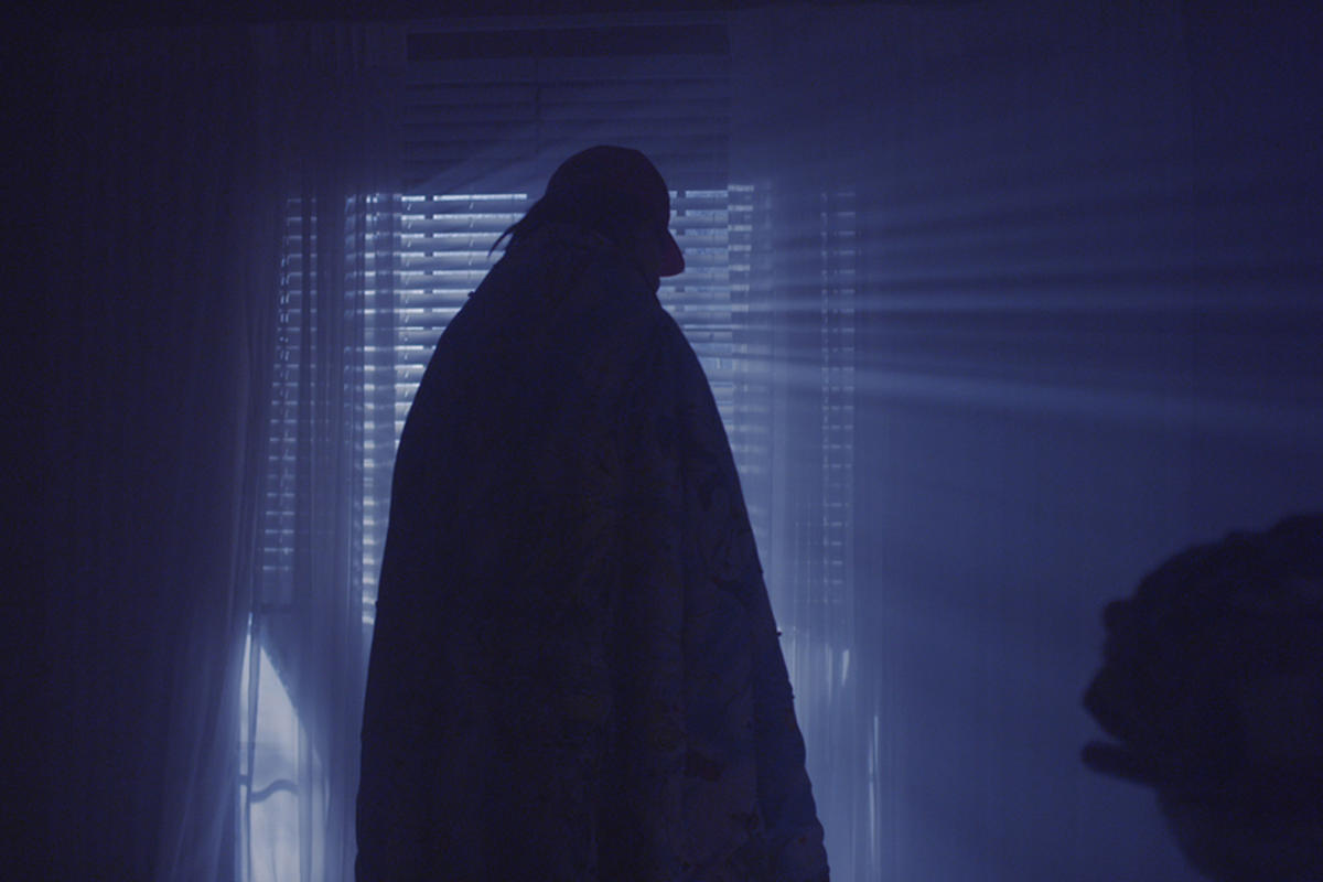 Silhouette of a person near a window