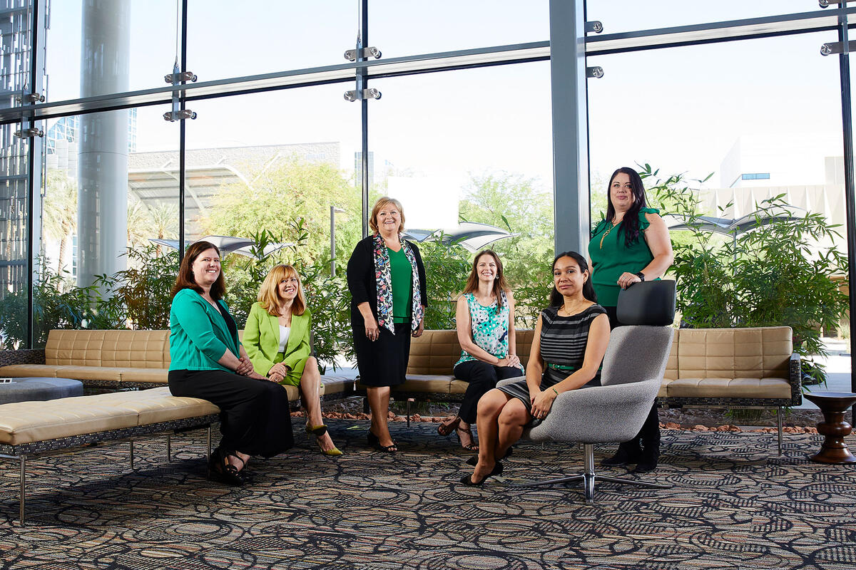 Six UNLV women researchers sitting down in a lounge area