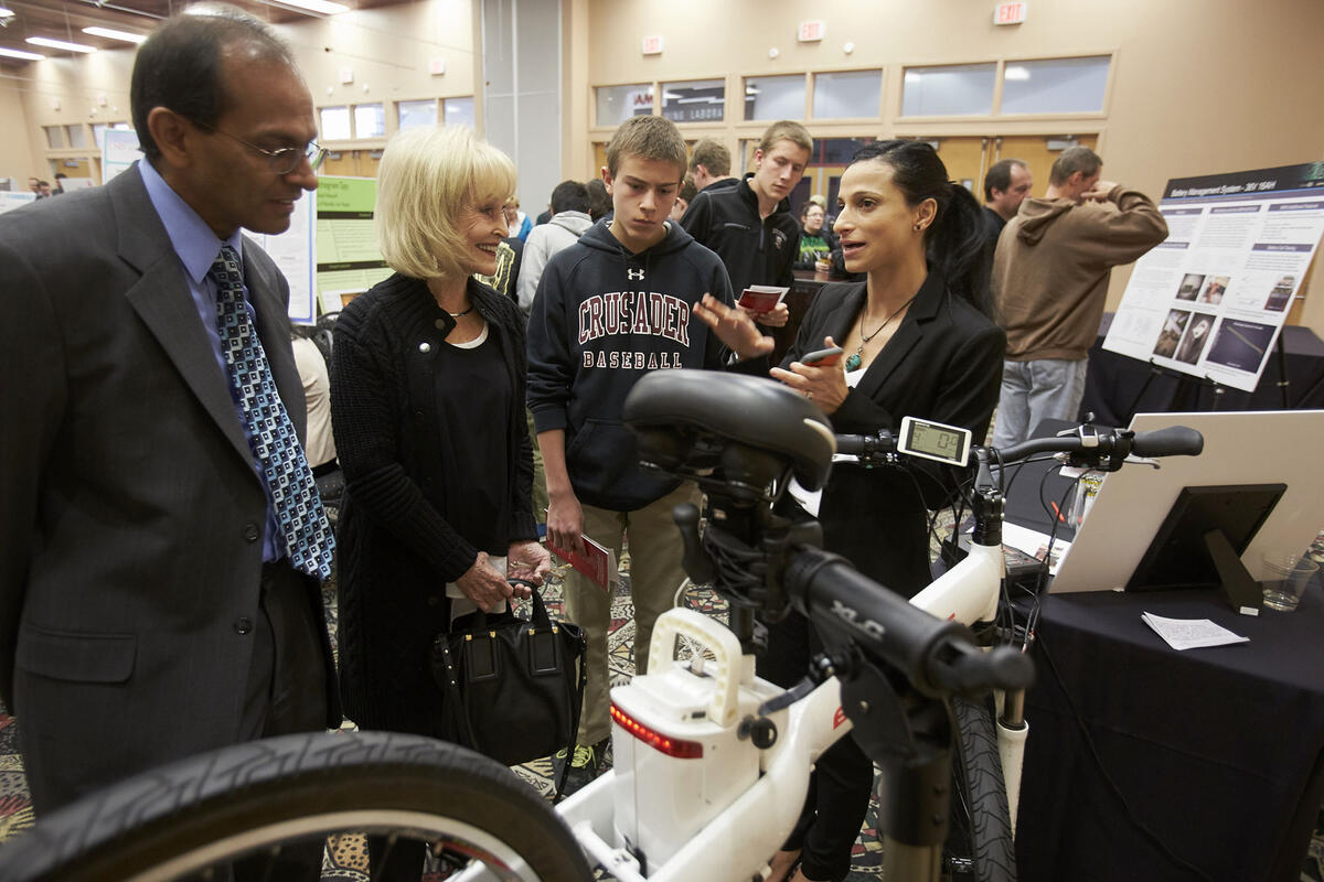 people gathered around a bicycle