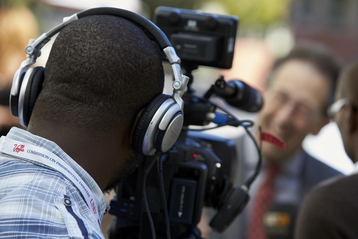 A man being interviewed by a videographer.