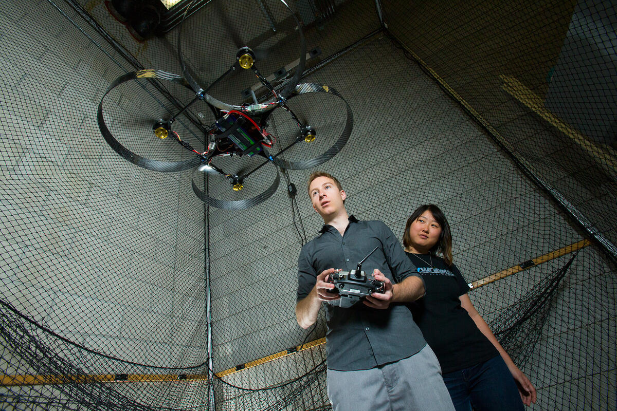 Two students testing an aerial drone