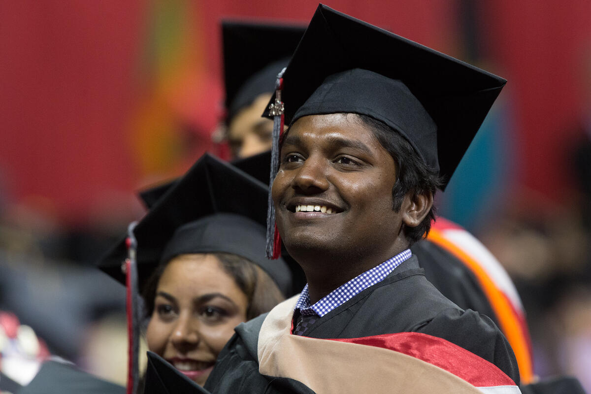 Graduate student smiling during Commencement