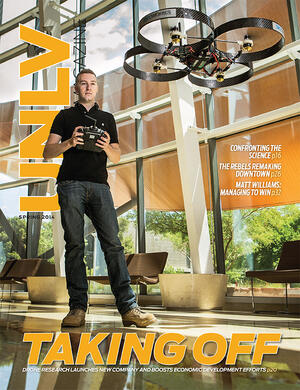 2014 magazine cover featuring a man piloting a drone in front of them