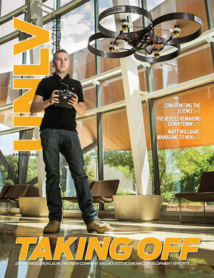 2014 magazine cover featuring a man piloting a drone in front of them
