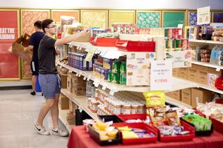 A student stocks the UNLV Food Pantry.
