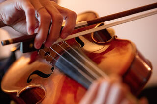 A woman's hand playing violin.