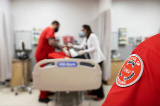 A UNLV Nursing badge in the foreground.