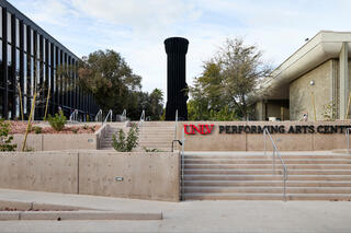 An updated 2026 image of the stairs and ramp leading up to the Performing Arts Center. In the background is the Flashlight sculpture.