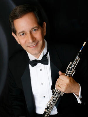 High resolution photo of Stephen Caplan holding his oboe