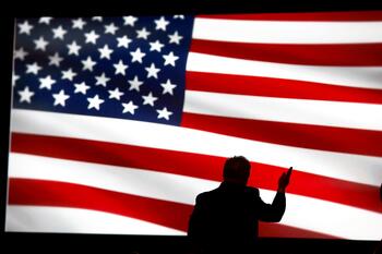 silhouette of speaker against American flag