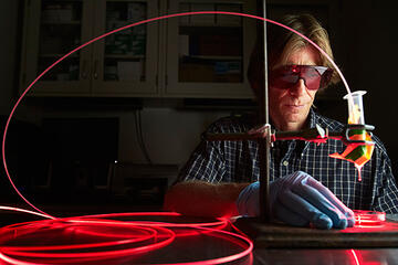 Steen Madsen works with lab equipment and while wearing eye protection
