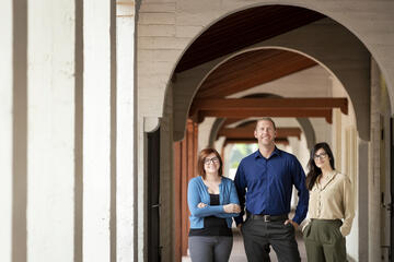 two women and a man in breezeway