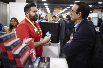 two men in talking at trade show