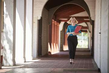 Miranda Berrie walking down a corridor
