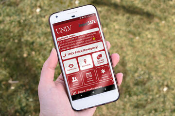 hand holding a phone with UNLV app displaying