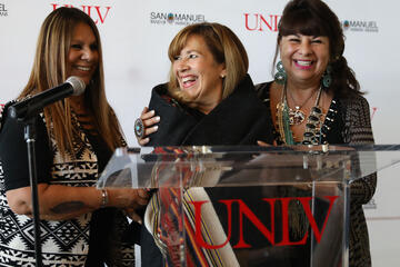 unlv president marta meana is wrapped in a blanket by audrey martinez and lynn valbuena
