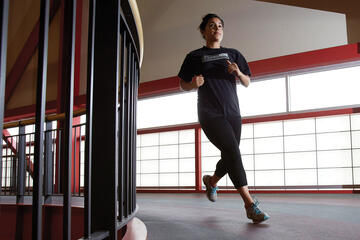 woman jogging on indoor track