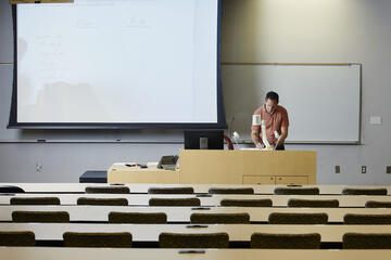 professor in empty classroom