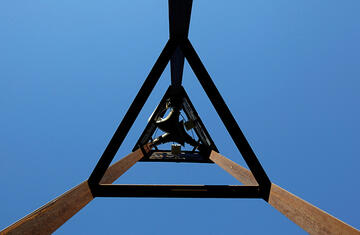 Bottom view of the watch tower sculpture and blue sky on UNLV campus.