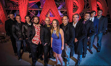 Amy Lee Finchem, middle, poses at the Neon Museum with artists and designers who competed in the Ogden Underground project. From left are, Joshua Vermillion, Clemente Cicoria, Zak Ostrowski, Dave Rowe, Jonathon Anderson, Finchem, Glen Curry, Eric Strain, Albert Brown, David Ryan and Drew Gregory. (Courtesy Tommy Natali/Shotgun Twins Productions)