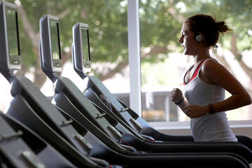 Student exercising on treadmill at the university gym.