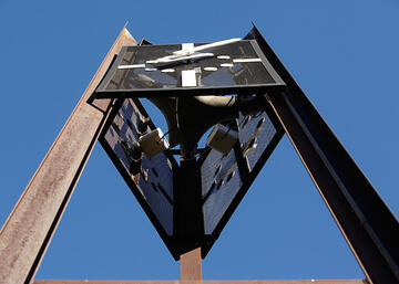 Close up low angle view of clock tower sculpture on UNLV campus.