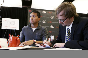 Two young men writing their thank you letters.