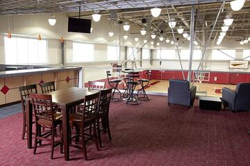 The lounge on the 4,000-square-foot mezzanine level offers a view of the courts.