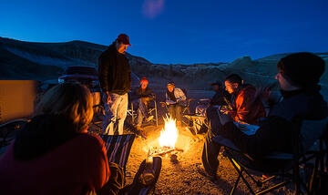 UNLV researchers sitting by a fire at night in Esmeralda County.