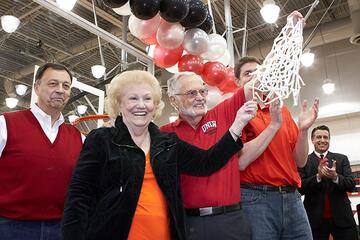The $13 million facility was funded fully through private support, led by the Mendenhall family. At the net-cutting ceremony, from left: athletics director Jim Livengood; donors Paula Mendenhall and Robert Mendenhall; head coach David Rice; and Gov. Brian Sandoval. The governor hosted a barbecue for UNLV Athletics right after the dedication on Jan. 19.