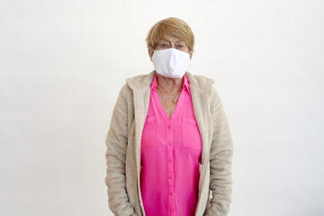 Sandy Stanton poses for a portrait wearing a face mask.