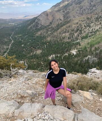 Blanca Pena at the top of a mountain overlooking a valley